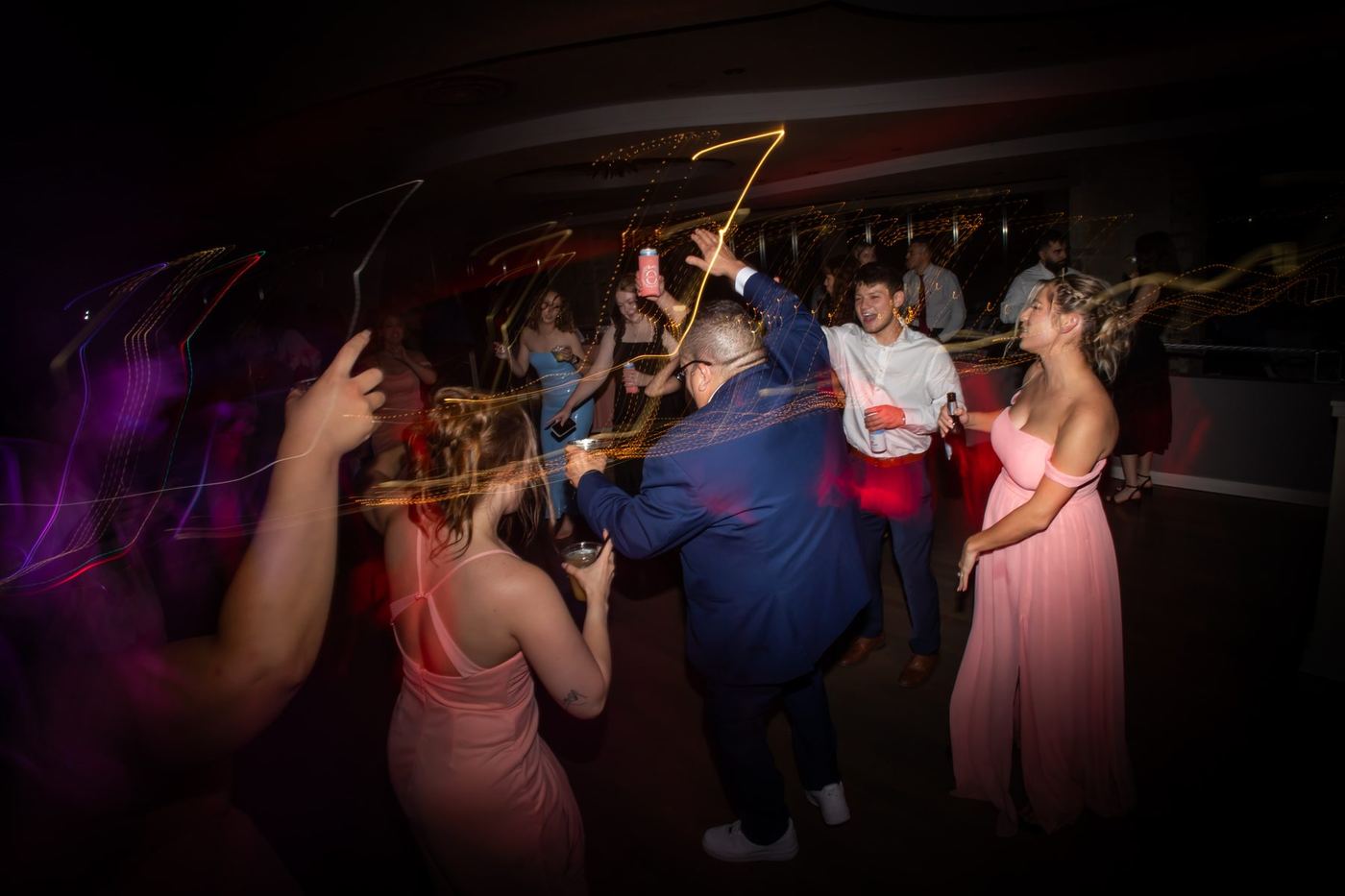 Guests dancing under moving lights