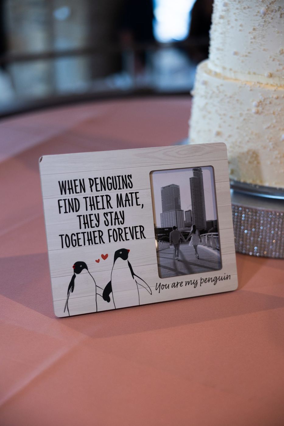 Wooden penguin photo frame on a blush tablecloth