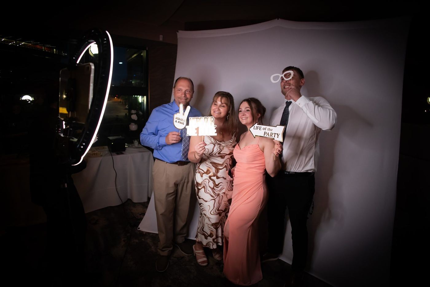 Guests posing with props in a photo booth