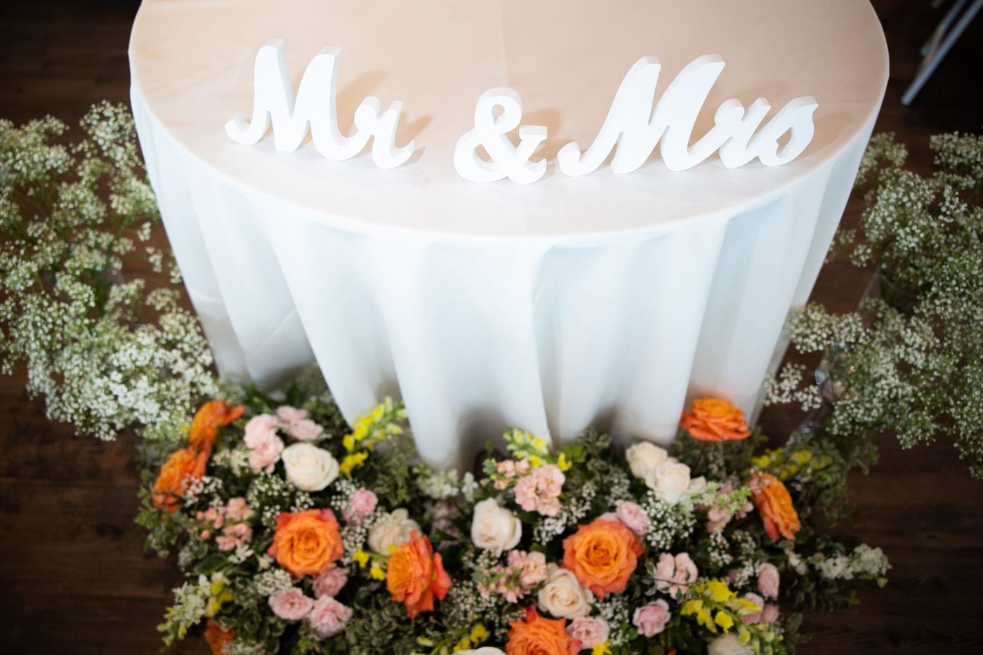 Sweetheart table with Mr and Mrs letters and a floral meadow