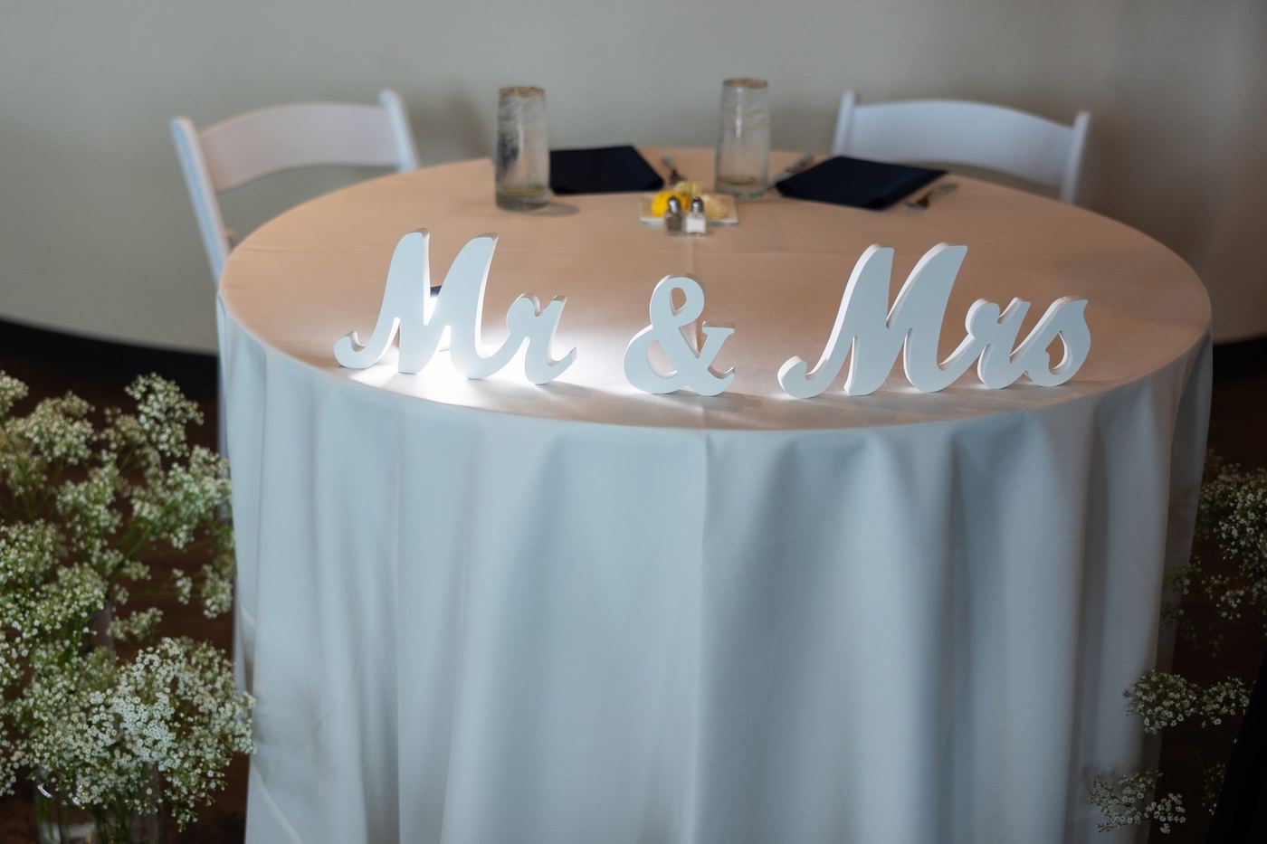 Sweetheart table with lit Mr and Mrs letters